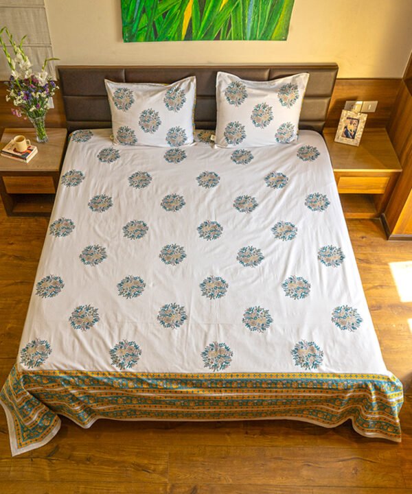 Blissful sun-kissed bed with king size organic cotton bedsheet draped in turquoise, white and peach colors