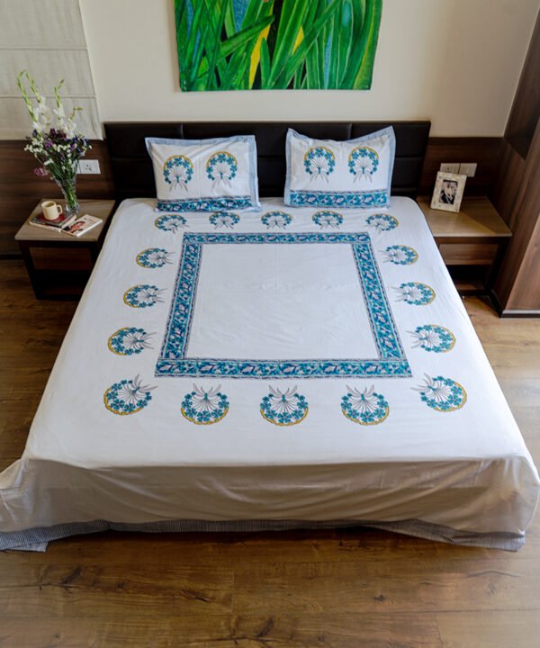 A cozy bedroom with kalaaais organic cotton king size bed sheet draped on its double bed in minimalistic block print design in blue and white color