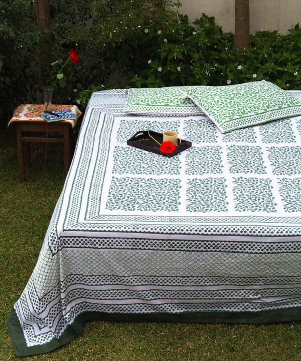 This is organic cotton bedsheet draped on a double bed nestled in the mid of a green meadow for slow morning coffee and a good read.