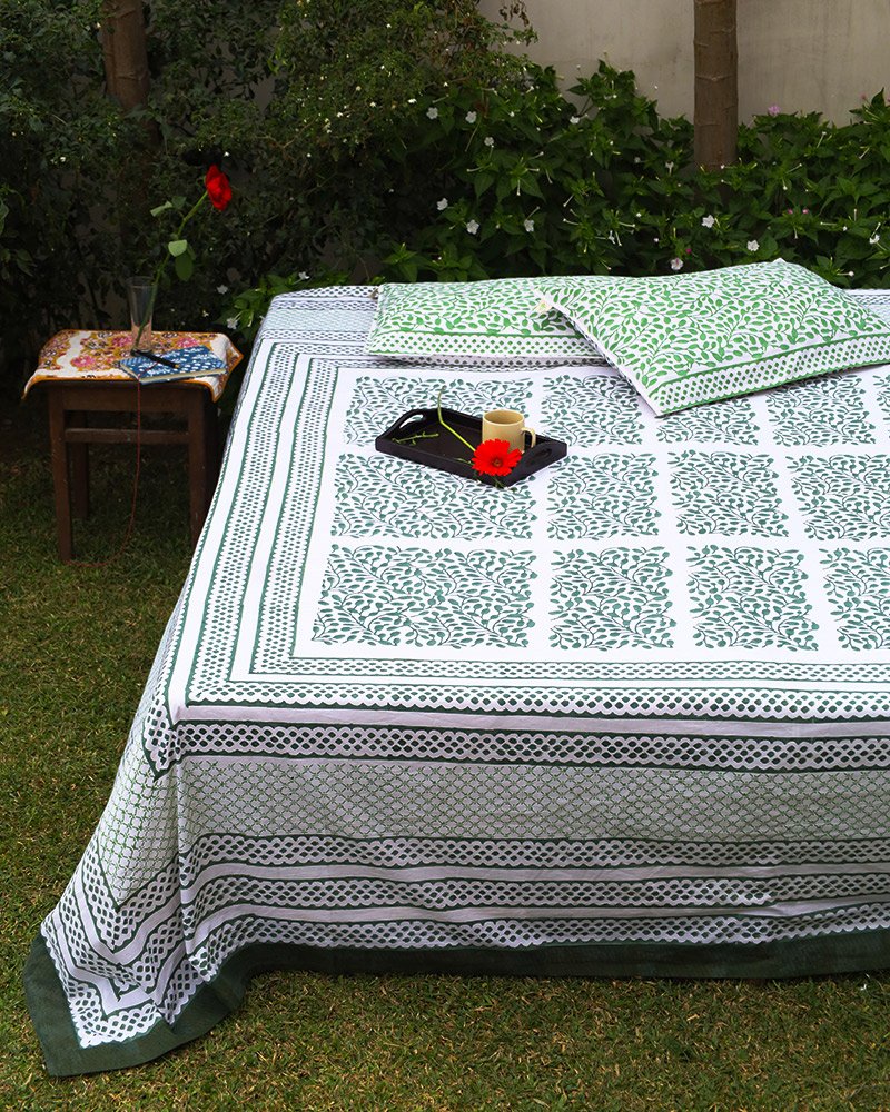 This is organic cotton bedsheet draped on a double bed nestled in the mid of a green meadow for slow morning coffee and a good read.