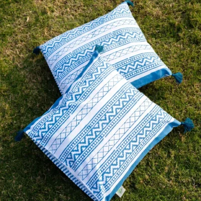 Victory Stripes organic cotton block print cushion cover with pom poms in blue colored striped design. Retirement gift by India's most trusted hand block print manfacturer.