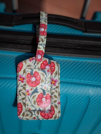 Bohemian Wanderer Upcycled Fabric Story Tag in Olive green with red roses. Features vibrant floral prints, rich paisleys, and intricate patterned patchwork in expressive colors. Handmade, 1-by-1 unique luggage tag collection made from zero-waste textile scraps.
