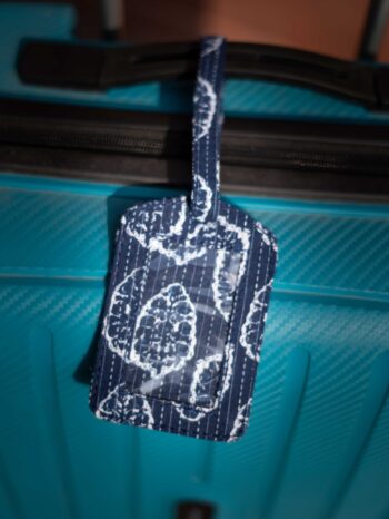 UPCYCLE ALERT: Meet the Zero-Waste Luggage Tag. Cluster of vibrant, unique Upcycled Fabric Story Tags. Launch banner emphasizing conscious travel and 1-by-1 artisan craftsmanship.