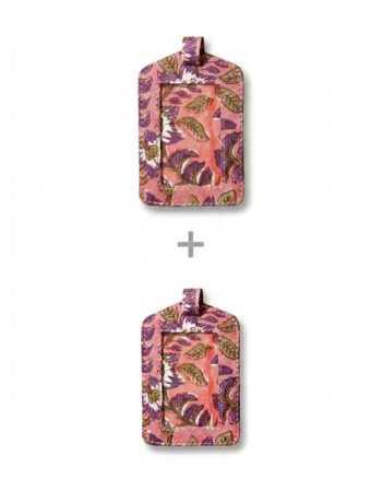 Two upcycled fabric luggage tags by kalaai studio, india. Both tags feature a pink background with a detailed hand block print pattern of purple flowers and brown leaves. Each tag has a clear, vinyl window for identification, a small pink loop at the top, and stitching around the edges.