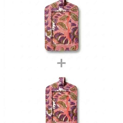 Two upcycled fabric luggage tags by kalaai studio, india. Both tags feature a pink background with a detailed hand block print pattern of purple flowers and brown leaves. Each tag has a clear, vinyl window for identification, a small pink loop at the top, and stitching around the edges.