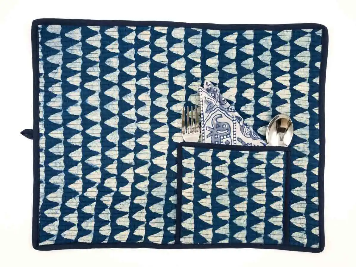 tile-mat Indigo Mosaic Roll-Up Travel Dining Mat by Kalaaai Jaipur featuring heritage-inspired geometric tile patterns in indigo and white, handcrafted quilted cotton construction, integrated cutlery pocket, spoon, fork, and reusable napkin for sustainable dining and travel.